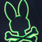 Close-up of a neon green embroidered logo of a rabbit head silhouette on a Psycho Bunny Pima cotton fabric background.