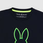 Close-up image of a black Pima cotton t-shirt collar with a neon green embroidered bunny logo and the brand name "Psycho Bunny" displayed above.