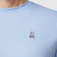 Close-up of a man wearing a Psycho Bunny MENS CLASSIC CREW NECK TEE - B6U014B200 with a small, embroidered pink and white bunny logo on the chest. Only the shirt and part of the man's neck and shoulder are visible.