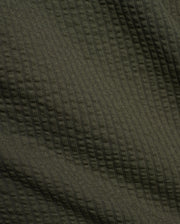 Psycho Bunny Mens Arlen Seersucker Short in dark olive green, featuring a classic seersucker fabric with a distinct puckered, vertically striped texture. (6)