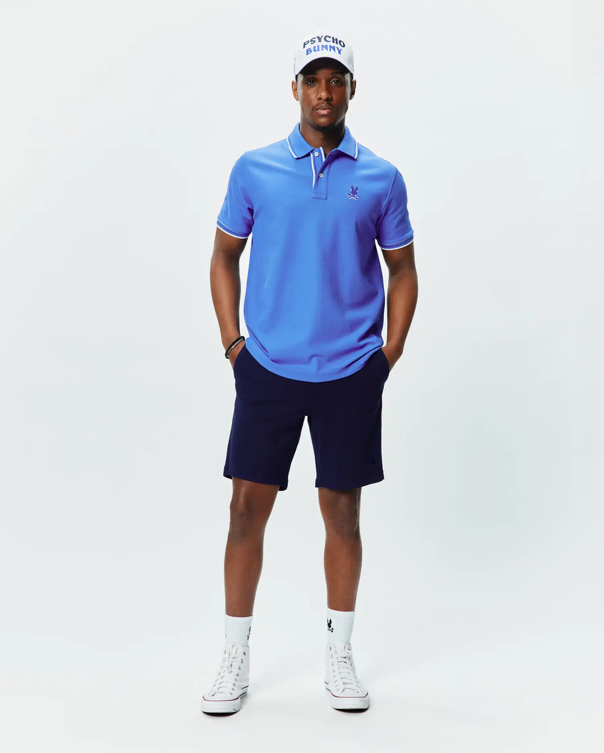 Mens Brad Pique Polo, vibrant blue classic fit pique polo with white tipping on collar and cuffs, featuring a small embroidered blue Psycho Bunny skull logo on the left chest. (3)