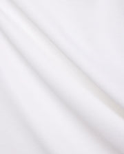 Crisp White Mens Brad Pique Polo fabric, highlighting its distinctive textured pique weave, soft, luxurious feel, and elegant folds, embodying premium Psycho Bunny menswear. (6)