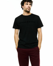 Black Mens Royce Graphic Tee, classic fit, smooth jersey knit, with a subtle tonal Psycho Bunny text and iconic skull logo graphic centered on the chest. (2)