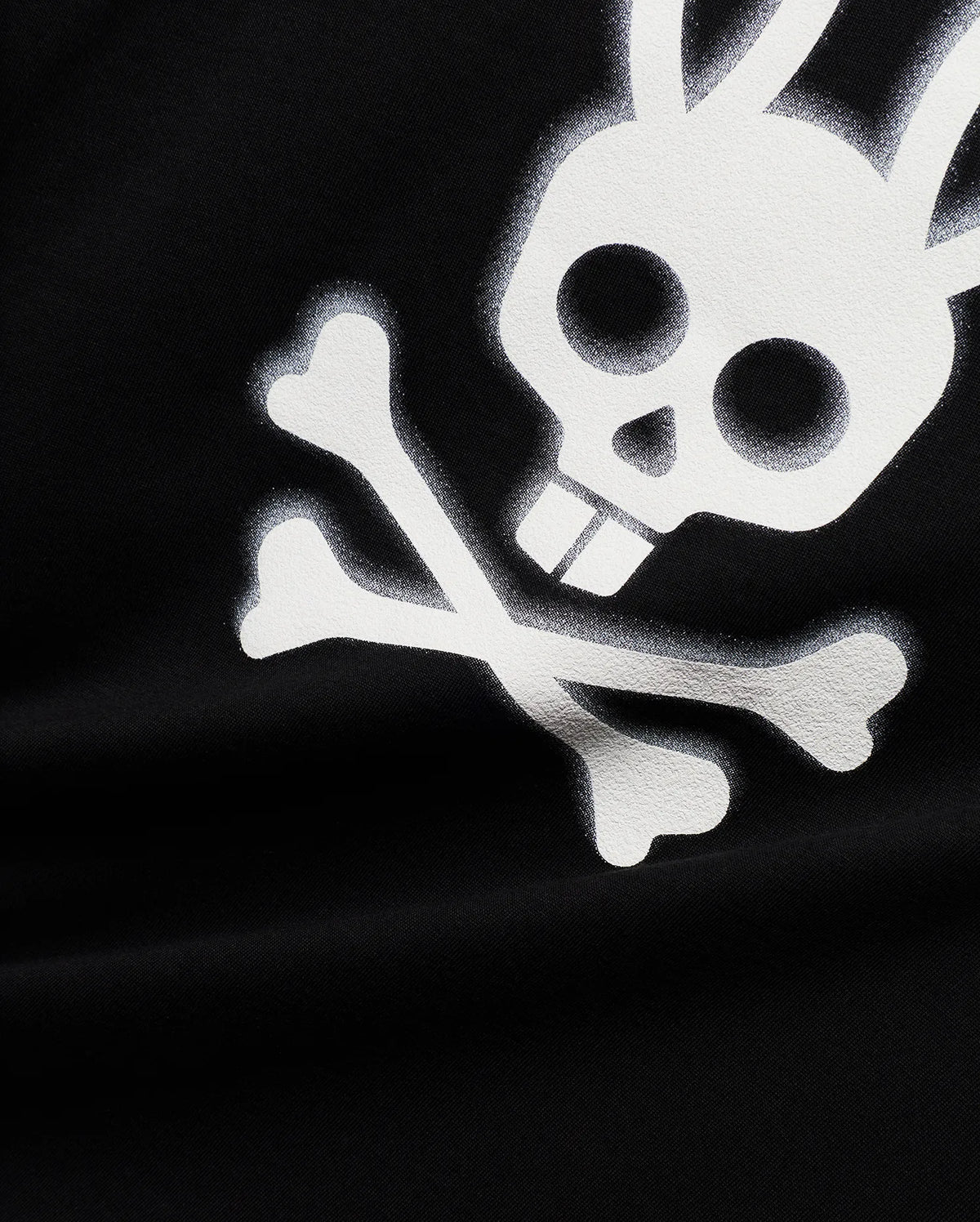Mens Emmanuel Pima Cotton Graphic Tee in black, showcasing a prominent, distressed white Psycho Bunny skull and crossbones graphic print on its soft jersey fabric. (6)