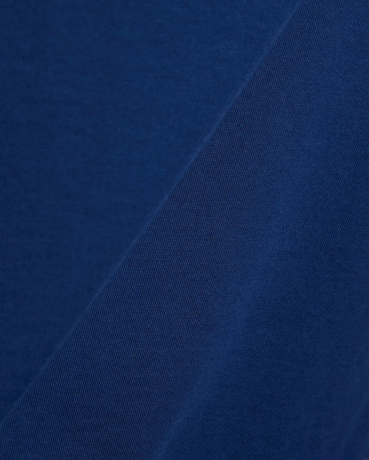 Mens Emmanuel Graphic Tee in rich navy blue, showcasing a soft, smooth jersey fabric on the main body, complemented by a finely textured, diagonal ribbed knit detail. (6)