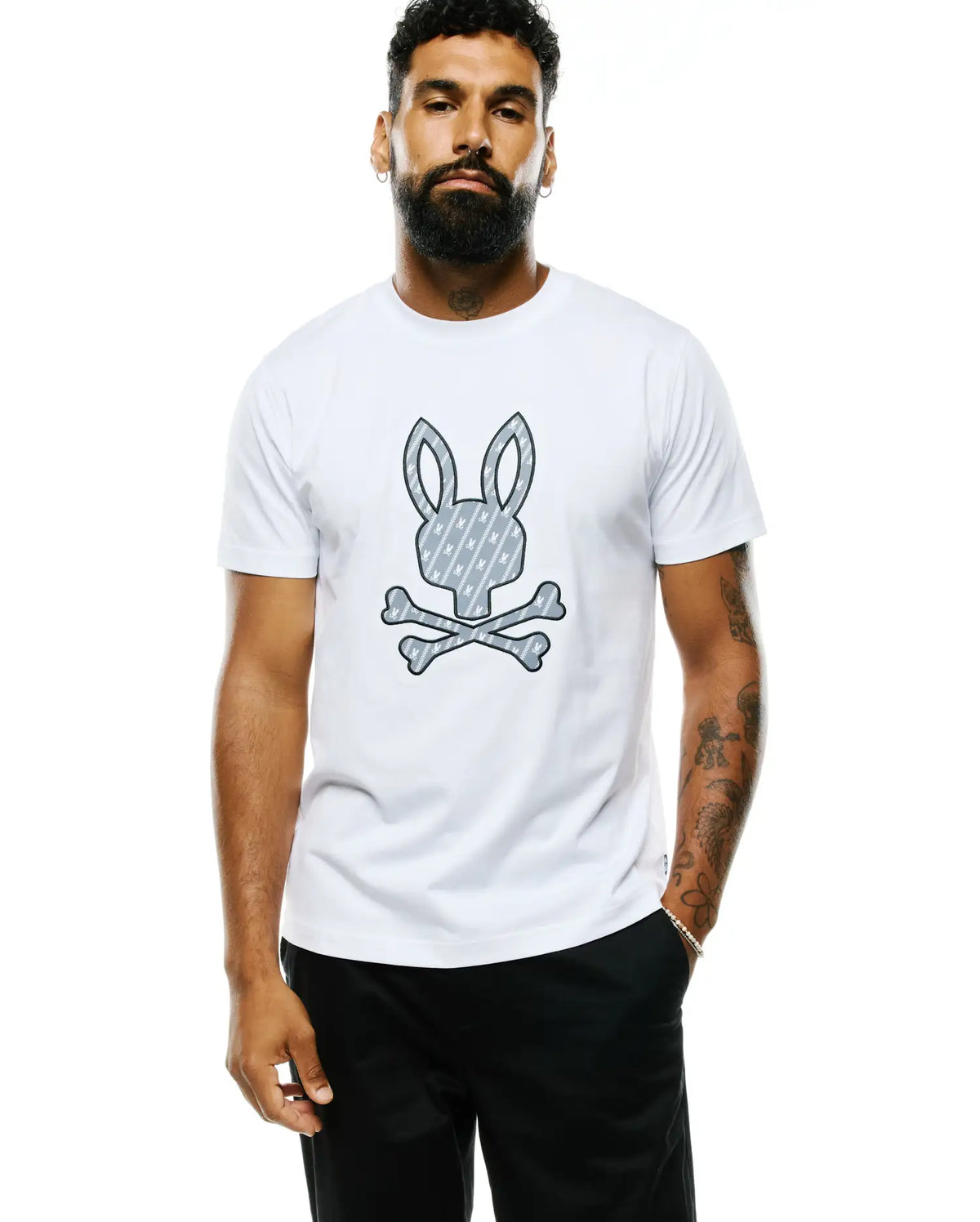 Mens Jaden Appliqué Graphic Tee, a white classic fit jersey t-shirt featuring a large central grey Psycho Bunny skull and crossbones graphic with an internal diagonal bunny pattern. (2)