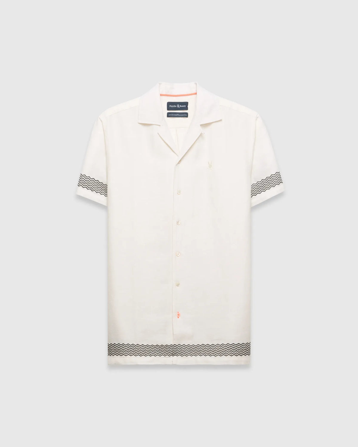 Mens Sunny Linen Shirt, an off-white relaxed linen camp collar shirt, features black zigzag patterns on sleeves and hem, an embroidered Psycho Bunny logo left chest, and orange collar trim. (5)