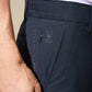 Close-up of a person wearing Psycho Bunny's MENS GABLE REGULAR FIT SPORT PANT in stretch cotton-nylon, featuring a side pocket and stitched with the silver 'psycho bunny' logo and bunny skull.