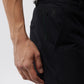 Close-up of a person's hand resting on the pocket of Psycho Bunny Men's Gable Regular Fit Sport Pants featuring a small HD Bunny print with a rabbit design.