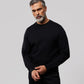 A middle-aged man with gray hair and a beard wearing a Psycho Bunny MENS OUTLINE SWEATSHIRT - B6S503ARCN and matching pants, standing against a plain light background. He looks confidently at the camera.