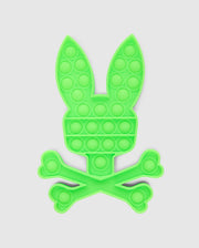 Introducing the PSYCHO BUNNY POP IT - B0A376E200 by Psycho Bunny, a premium silicone fidget toy designed in the shape of a bunny head above a crossbones, set against a white background.