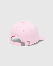 A light pink KIDS CLASSIC BASEBALL CAP - B0A816A1HT by Psycho Bunny is shown from the back, featuring an adjustable fit and sleek metal clasp. The plain light grey background enhances the timeless elegance of this piece.