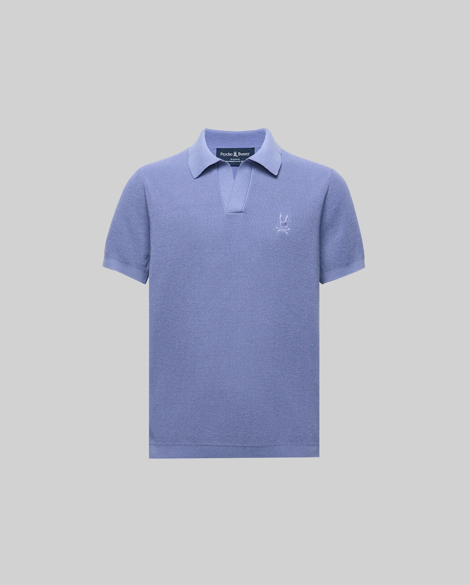 The KIDS LEETON KNIT POLO SHIRT (B0E562F200) by Psycho Bunny is a light purple cotton sweater polo with short sleeves, a Johnny collar, and an embroidered logo on the left chest, shown against a plain light gray background.