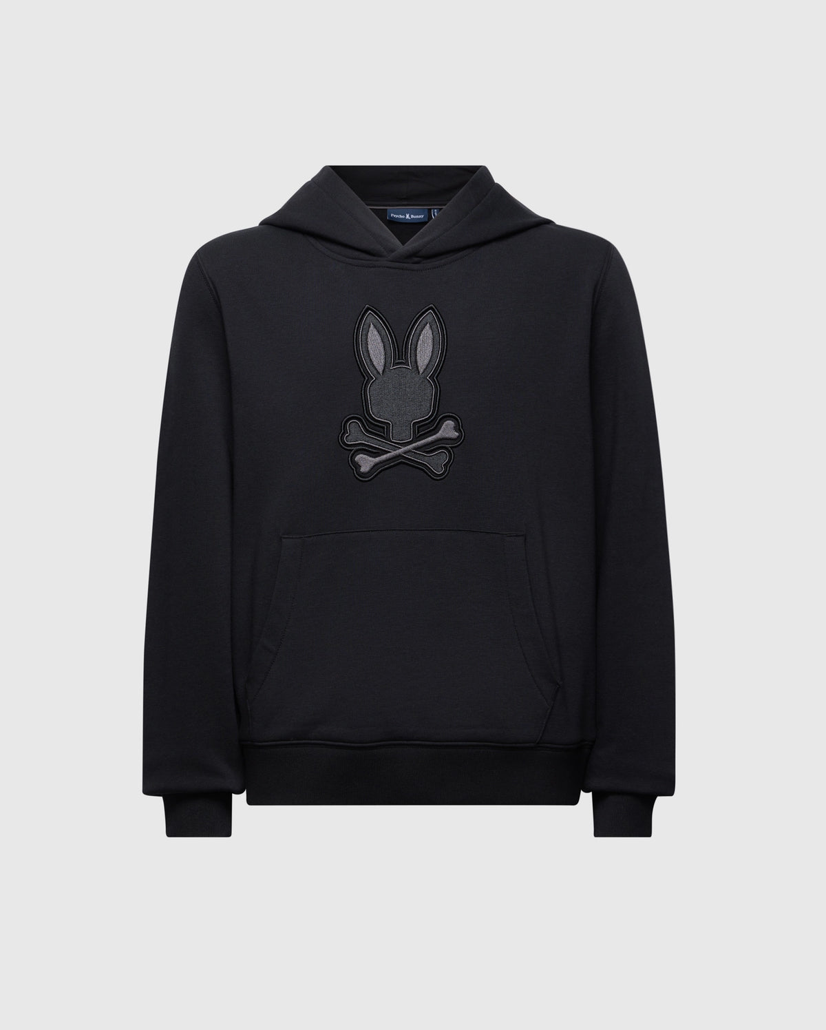 Introducing the KIDS NEW CASTLE FRENCH TERRY HOODIE by Psycho Bunny: a cozy black sweatshirt featuring a playful embroidered Bunny design with a rabbit head above crossed bones, perfectly contrasting its light gray background.