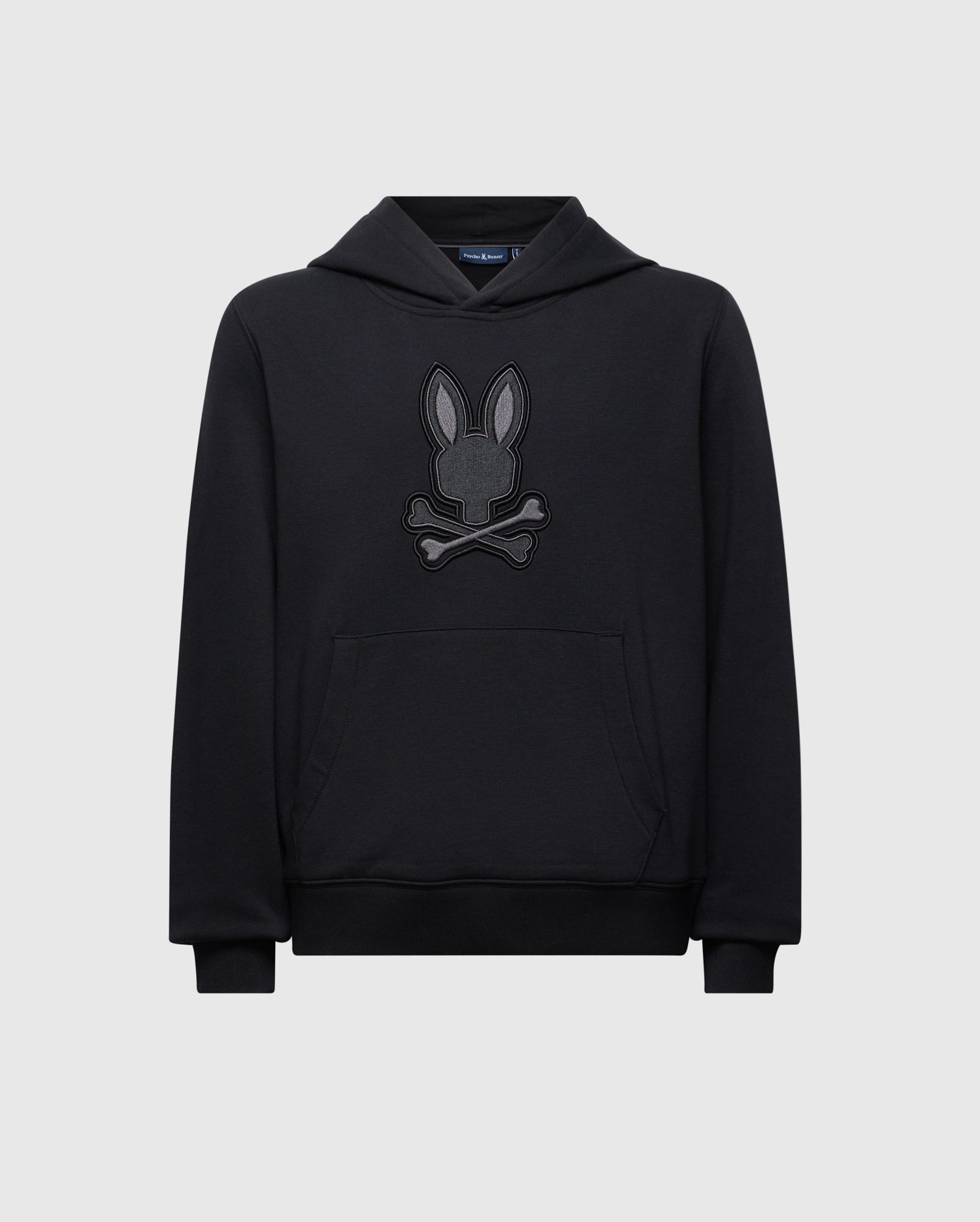 Introducing the KIDS NEW CASTLE FRENCH TERRY HOODIE by Psycho Bunny: a cozy black sweatshirt featuring a playful embroidered Bunny design with a rabbit head above crossed bones, perfectly contrasting its light gray background.