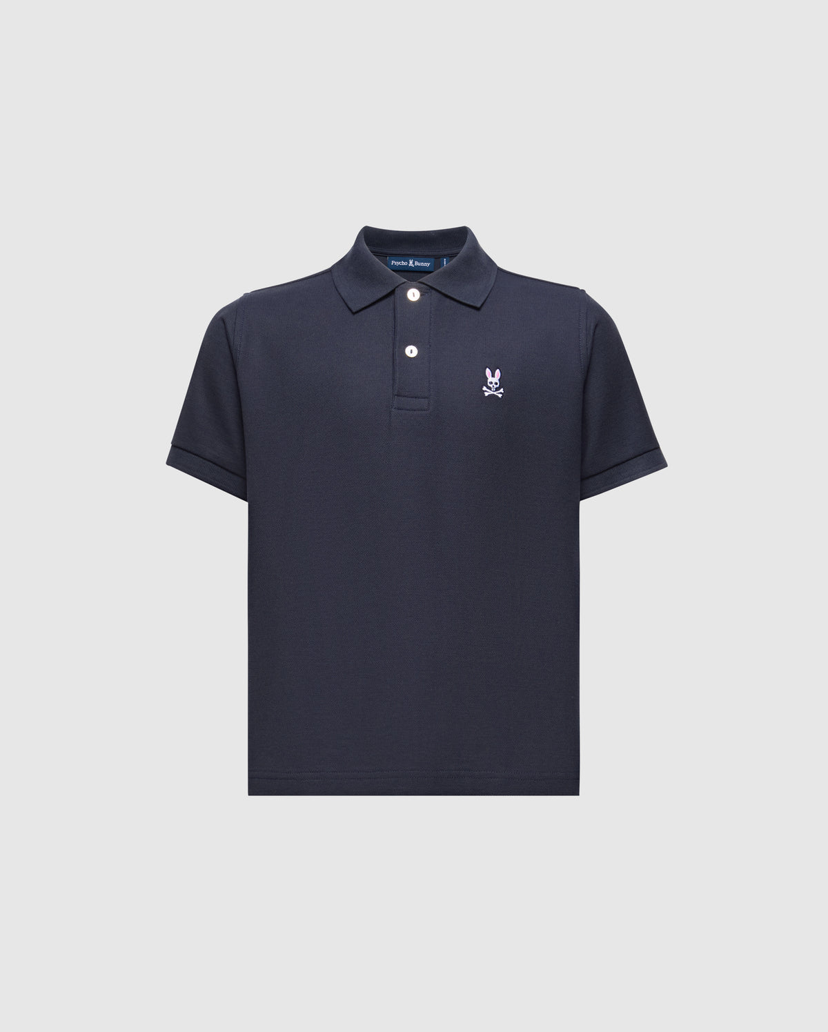 The Psycho Bunny Kids Classic Pique Polo Shirt (B0K001CRPC) in navy blue is ideal for back-to-school wear, with short sleeves and a white embroidered cartoonish rabbit skull and crossbones logo on the left chest. It features a buttoned placket and classic collar for an iconic look.
