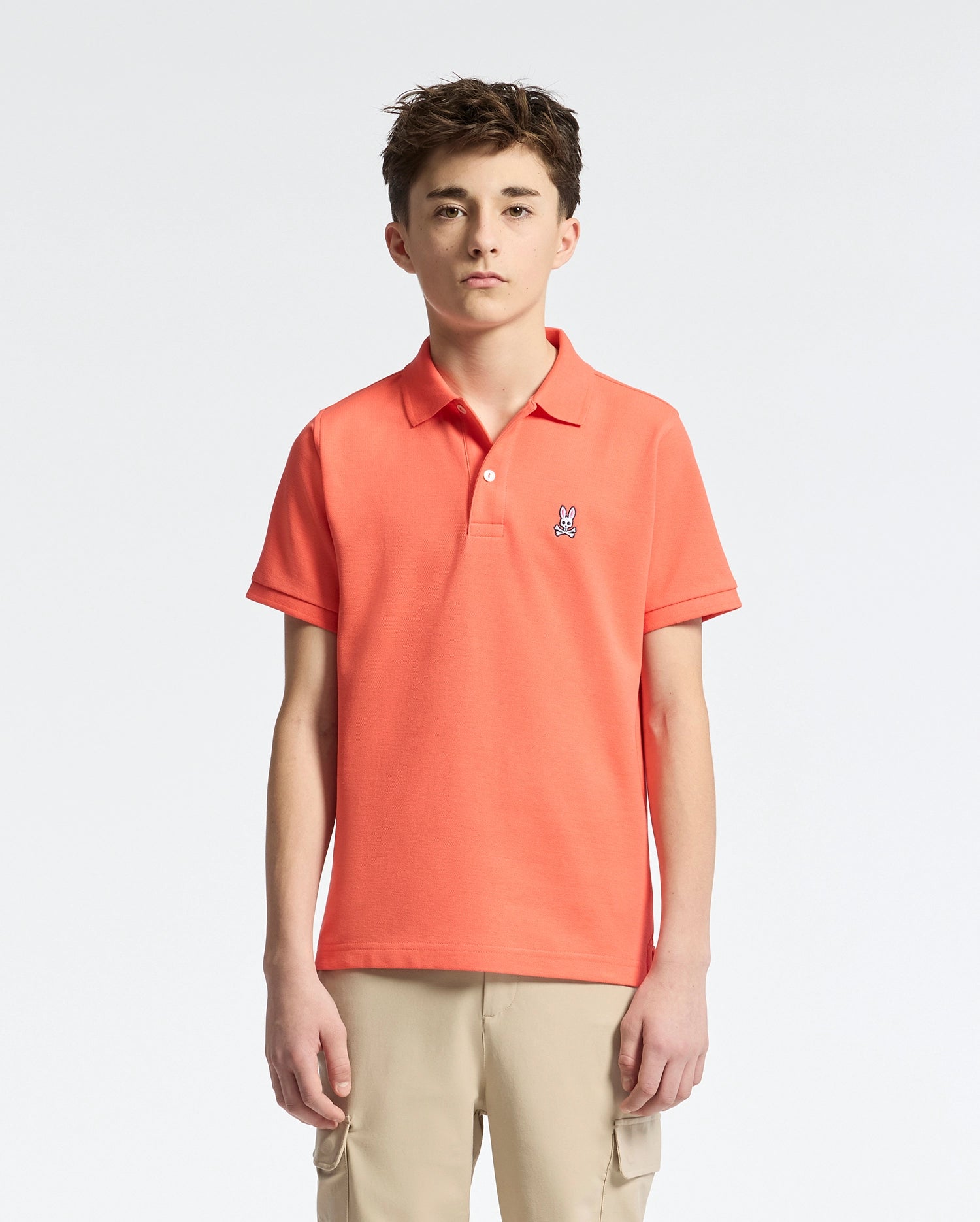 Teen | Kids' hot coral Psycho Bunny classic polo with embroidered logo, ribbed collar, and soft Pima cotton fabric for comfort and style.