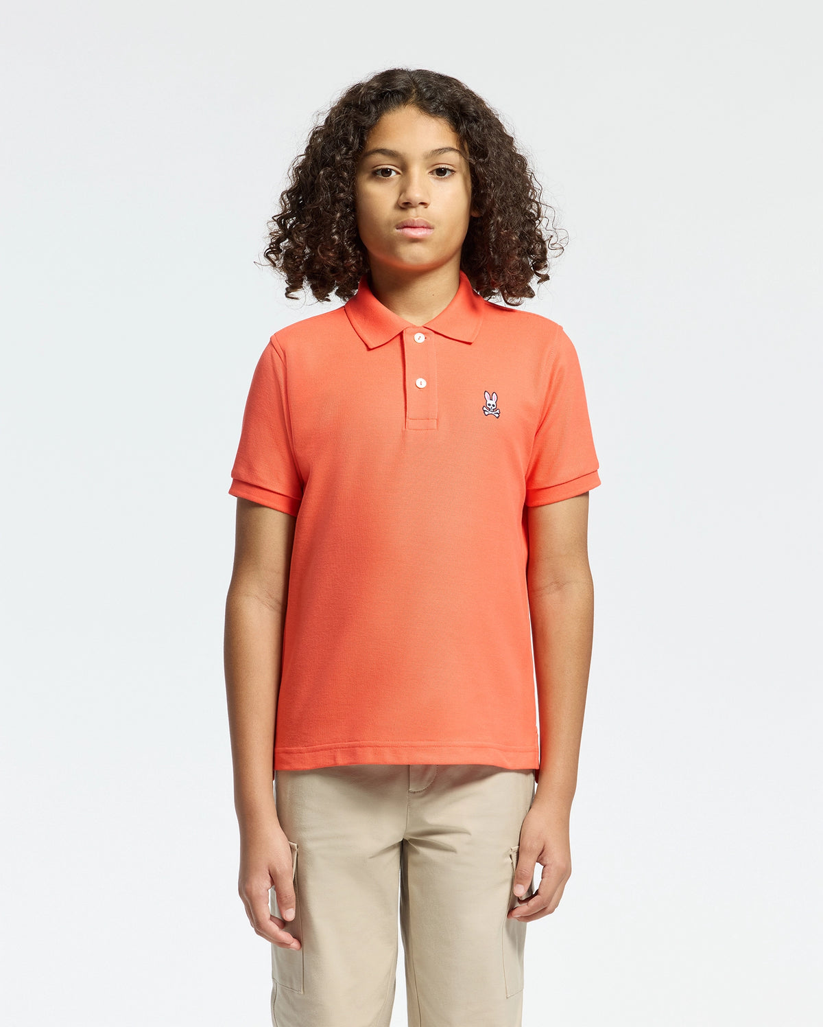 Kids | Kids' hot coral Psycho Bunny classic polo with embroidered logo, ribbed collar, and soft Pima cotton fabric for comfort and style.
