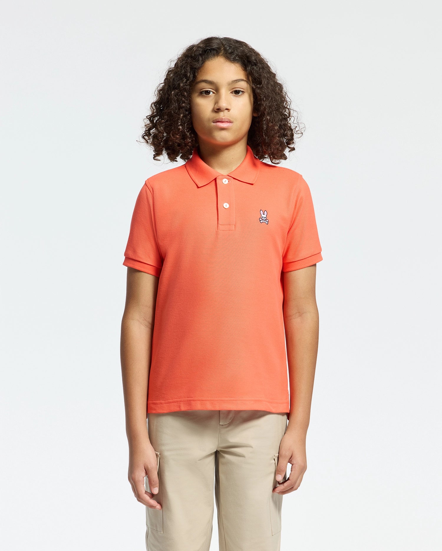 Kids | Kids' hot coral Psycho Bunny classic polo with embroidered logo, ribbed collar, and soft Pima cotton fabric for comfort and style.