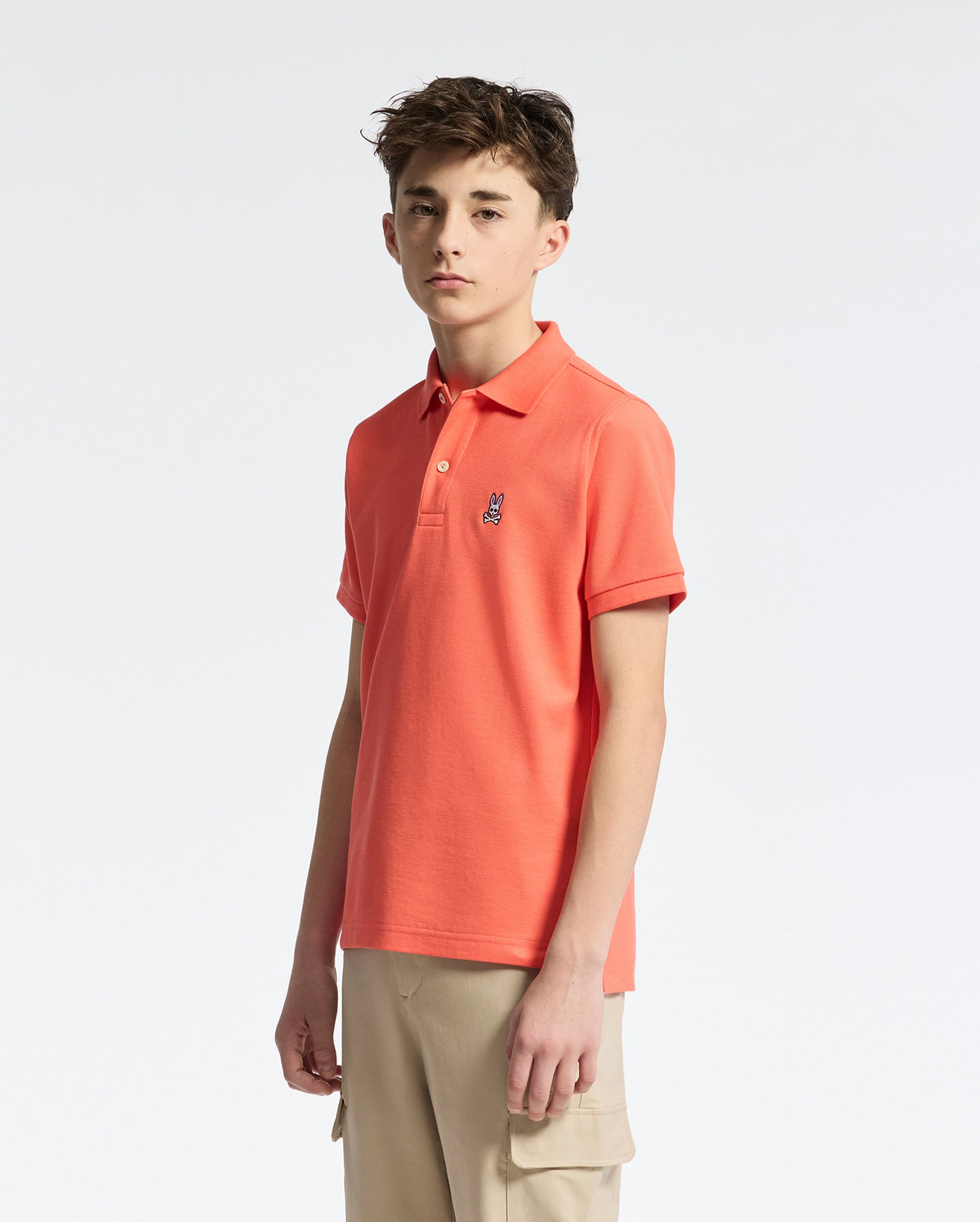 Teen | Kids' hot coral Psycho Bunny classic polo with embroidered logo, ribbed collar, and soft Pima cotton fabric for comfort and style.