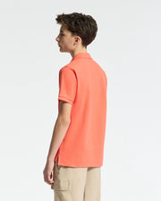 Teen | Kids' hot coral Psycho Bunny classic polo with embroidered logo, ribbed collar, and soft Pima cotton fabric for comfort and style.