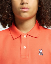 Kids | Kids' hot coral Psycho Bunny classic polo with embroidered logo, ribbed collar, and soft Pima cotton fabric for comfort and style.