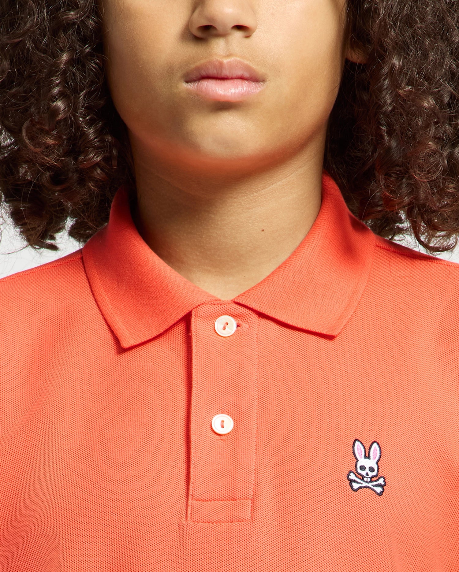 Kids | Kids' hot coral Psycho Bunny classic polo with embroidered logo, ribbed collar, and soft Pima cotton fabric for comfort and style.