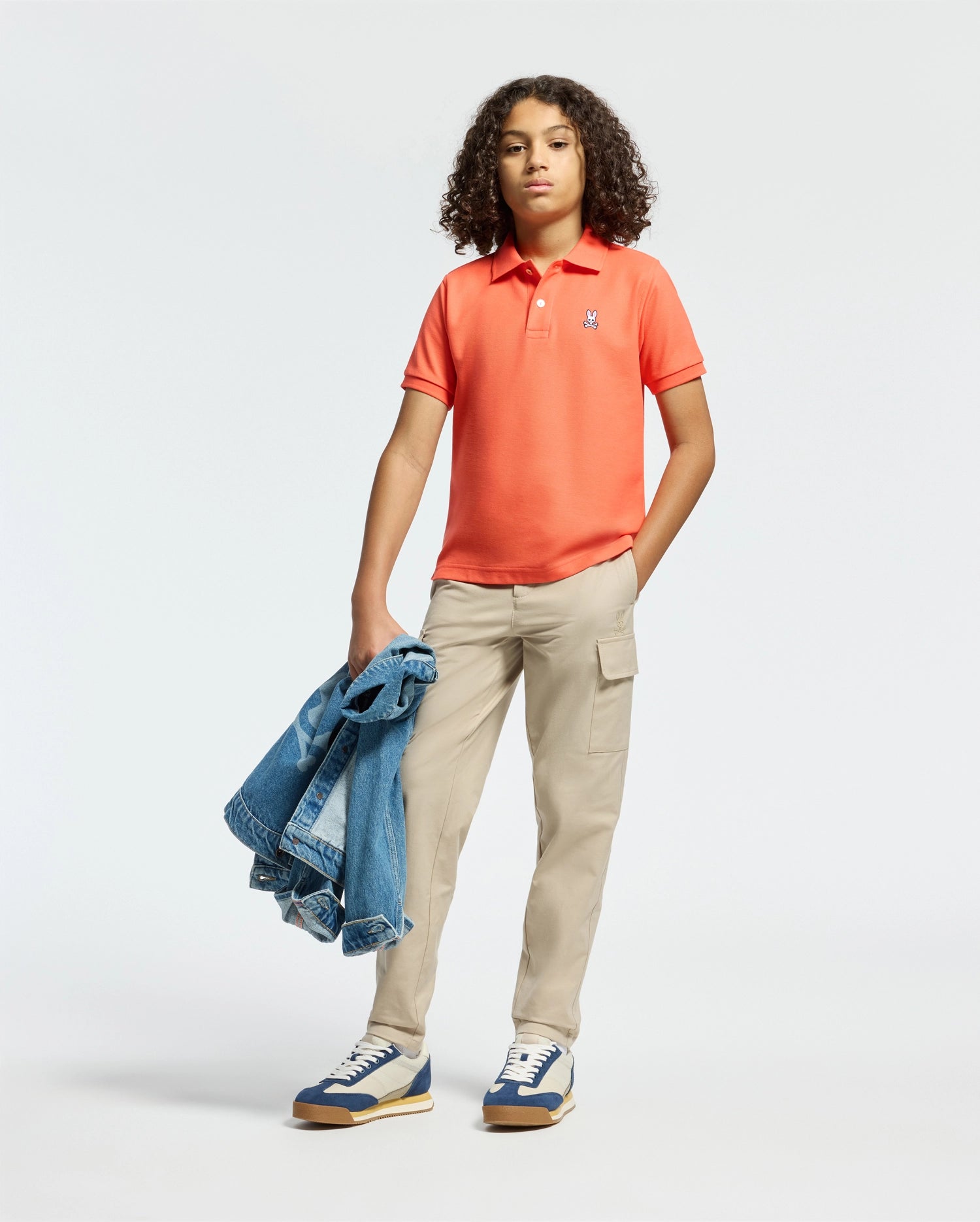 Kids | Kids' hot coral Psycho Bunny classic polo with embroidered logo, ribbed collar, and soft Pima cotton fabric for comfort and style.