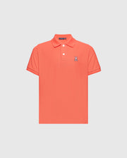 The KIDS CLASSIC PIQUE POLO - B0K001F200 by Psycho Bunny is a coral polo shirt made from premium Pima cotton, featuring short sleeves and a buttoned collar. A small embroidered Bunny logo adds elegance to the left chest on its plain white backdrop.
