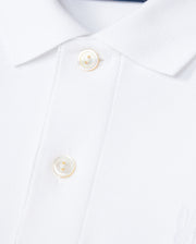 The KIDS CLASSIC PIQUE POLO SHIRT by Psycho Bunny, crafted from Pima cotton, features two white buttons on the placket and an embroidered Bunny that enhances the charm of its textured piqué weave.