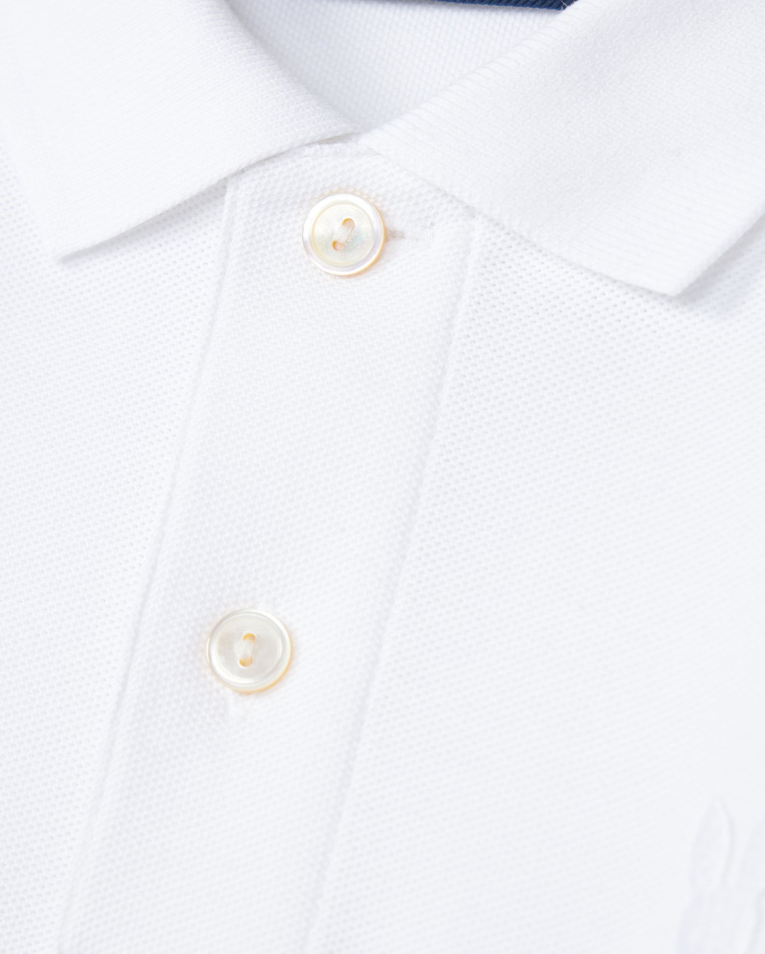 The KIDS CLASSIC PIQUE POLO SHIRT by Psycho Bunny, crafted from Pima cotton, features two white buttons on the placket and an embroidered Bunny that enhances the charm of its textured piqué weave.