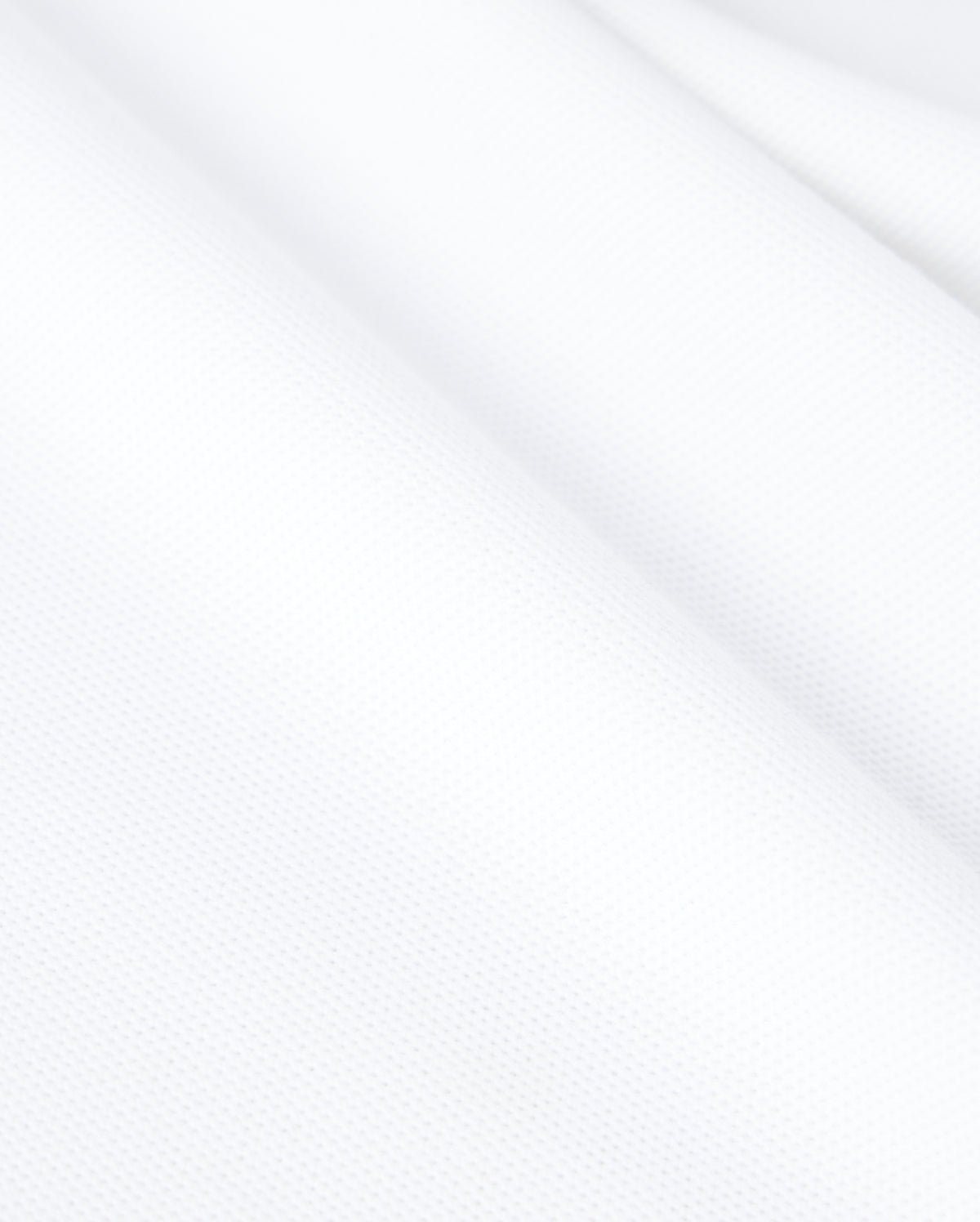 Psycho Bunny's KIDS CLASSIC PIQUE POLO SHIRT - B0K021AR00 is made from white textured Pima cotton with a slightly wavy surface, revealing a fine weave and smooth appearance ideal for a classic polo.