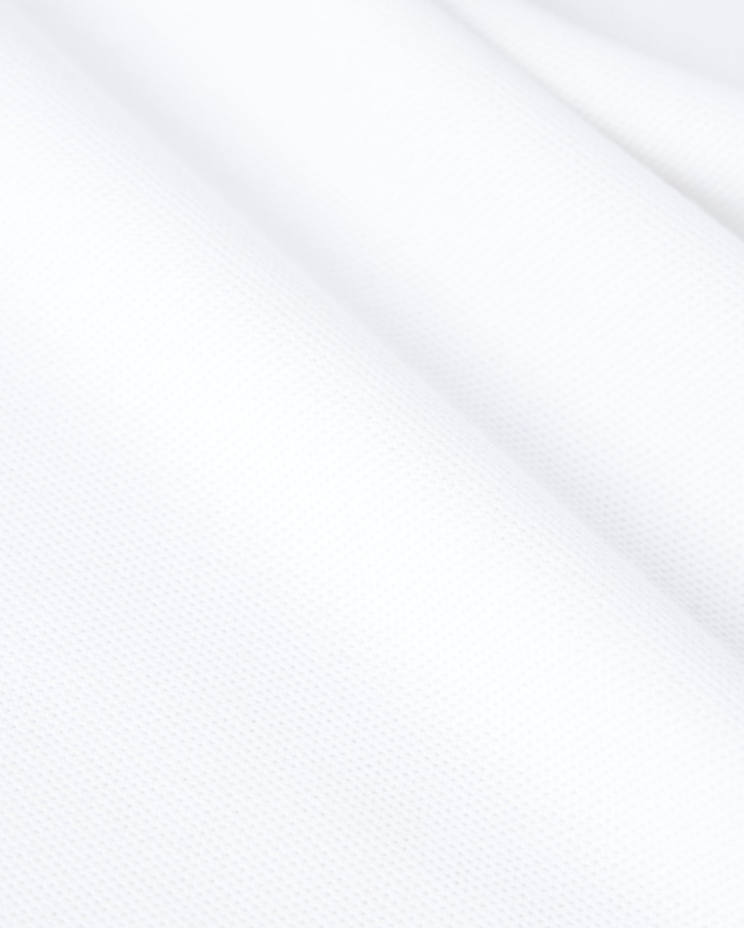 Psycho Bunny's KIDS CLASSIC PIQUE POLO SHIRT - B0K021AR00 is made from white textured Pima cotton with a slightly wavy surface, revealing a fine weave and smooth appearance ideal for a classic polo.