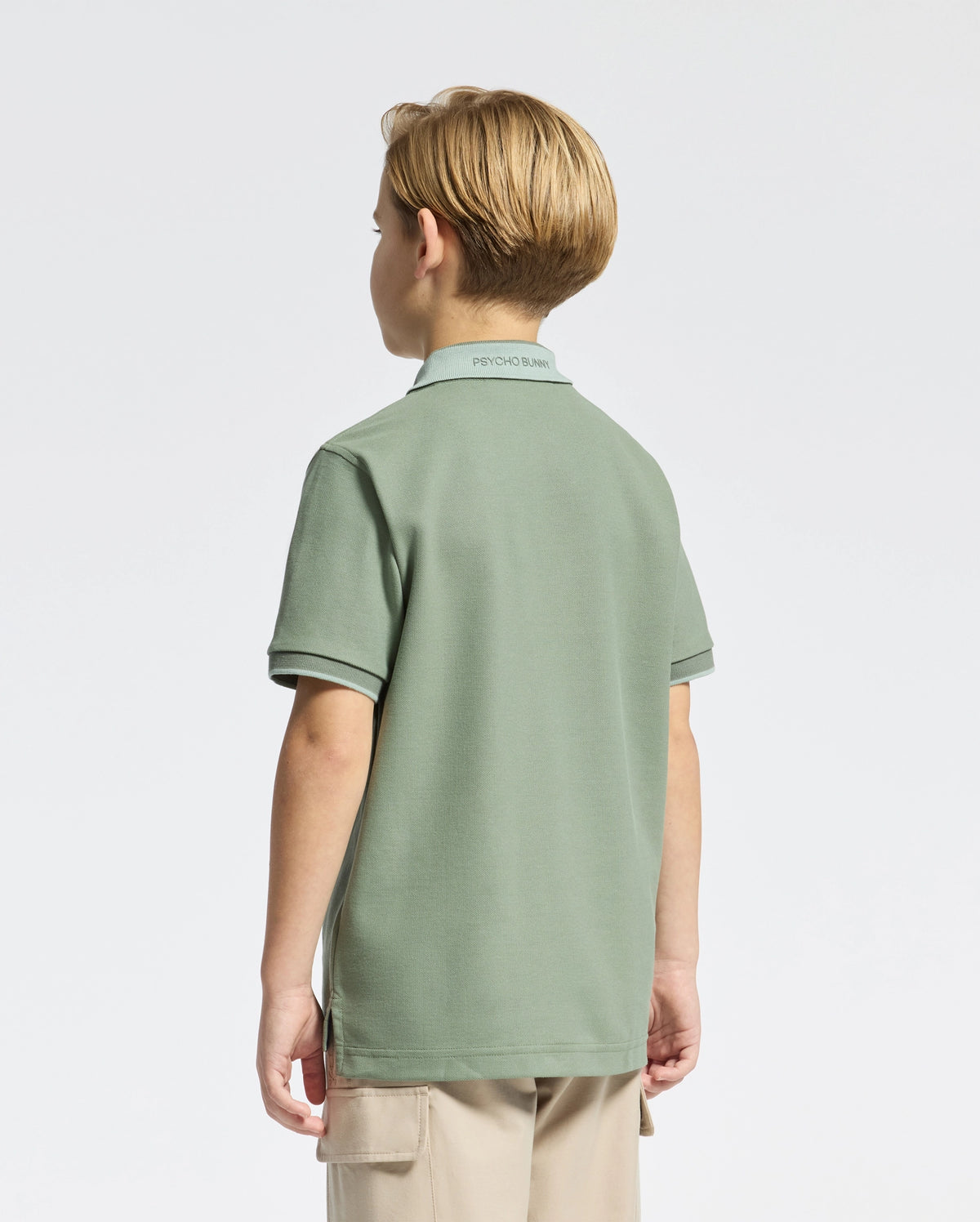 Kids | Kids' New Castle Piqué Polo in green by Psycho Bunny, featuring an embroidered logo and a classic design for a stylish, polished look.