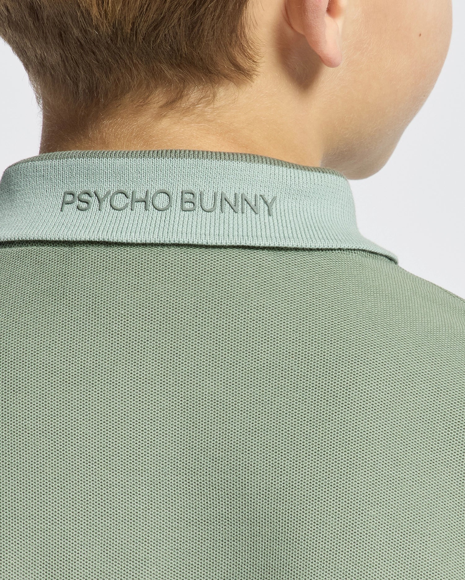 Kids | Kids' New Castle Piqué Polo in green by Psycho Bunny, featuring an embroidered logo and a classic design for a stylish, polished look.