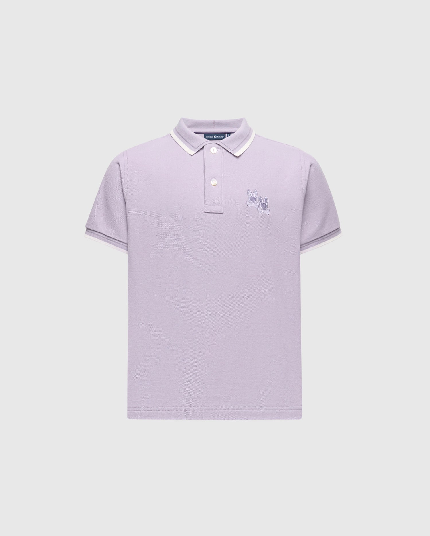 The KIDS ELLIOT PIQUE POLO - B0K505F200 by Psycho Bunny is a stylish lavender Pima cotton polo with white trim on the collar and sleeves. It features two cartoon-like rabbits embroidered on the left chest against a light gray background.