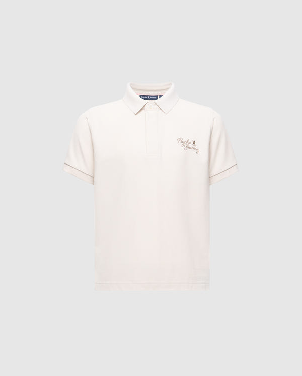 The KIDS DESERT PIQUE POLO from Psycho Bunny in cream offers timeless style with a collar, short sleeves, and subtle left chest embroidery of text and a logo. Crafted from luxurious Pima cotton, its light gray background adds to its classic elegance.