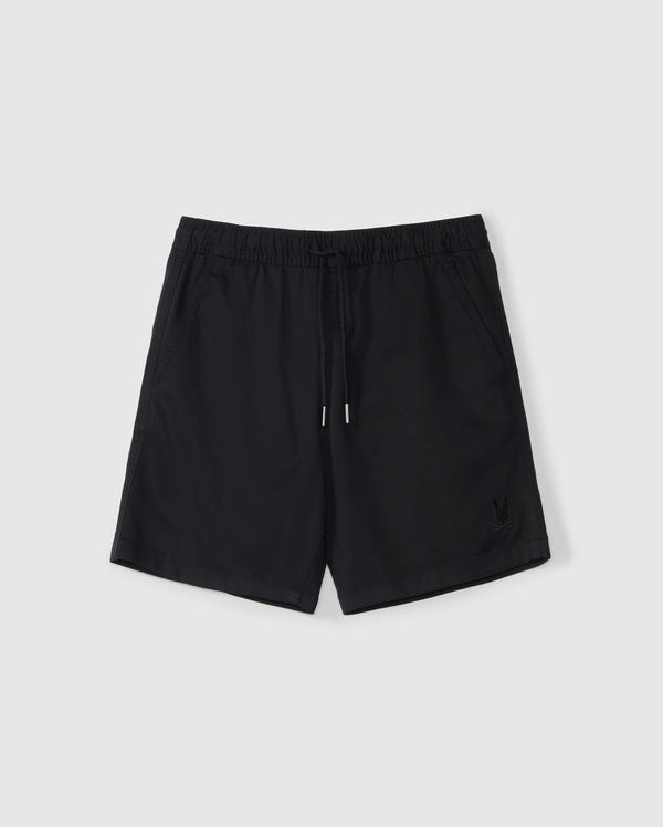 A pair of black athletic shorts with an elastic waistband and a drawstring. The slim fit shorts feature two side pockets and a small embroidered Bunny logo on the bottom left front. Made from a Stretch TENCEL-blend, they are displayed on a plain white background. The product is the KIDS WILLIS STRETCH TENCEL SHORT - B0R239Y1WB by Psycho Bunny.