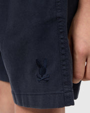 Close-up of a black shirt sleeve featuring an embroidered logo of a small rabbit, with the focus on the texture of the Psycho Bunny Tencel-blend twill and the detailed stitching of the logo.