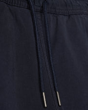 Close-up of a black fabric drawstring with metal aglets on Psycho Bunny's KIDS WILLIS STRETCH TENCEL SHORT - B0R239Y1WB clothing, focusing on the texture and details of the material and drawstring.