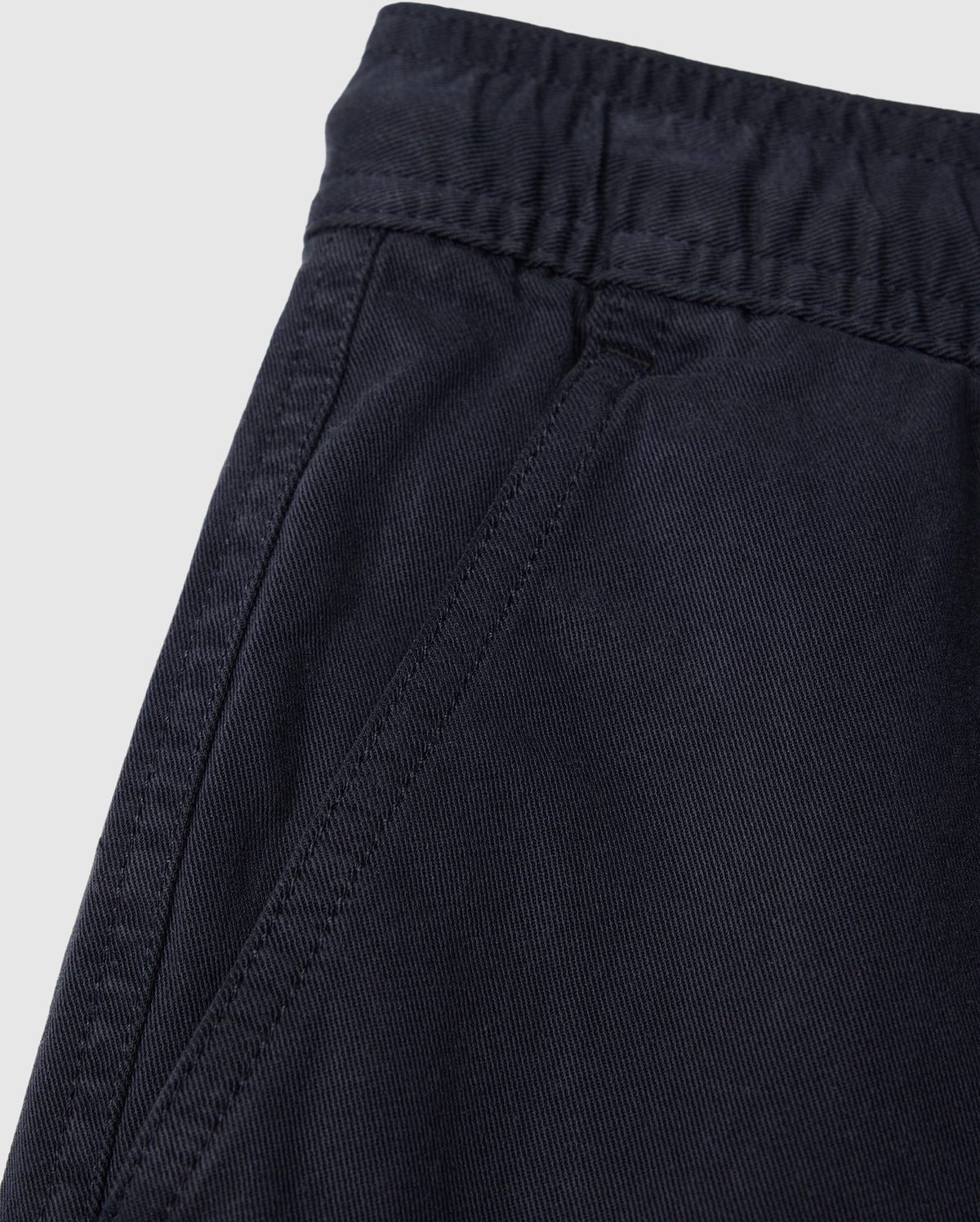 Close-up of a dark blue elasticized waistband on Psycho Bunny Kids Willis Stretch Tencel Shorts with detailed stitching and fabric texture.