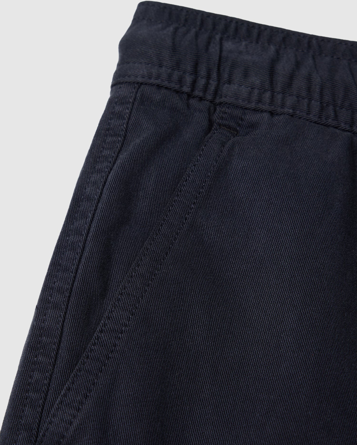 Close-up of a dark blue elasticized waistband on Psycho Bunny Kids Willis Stretch Tencel Shorts with detailed stitching and fabric texture.