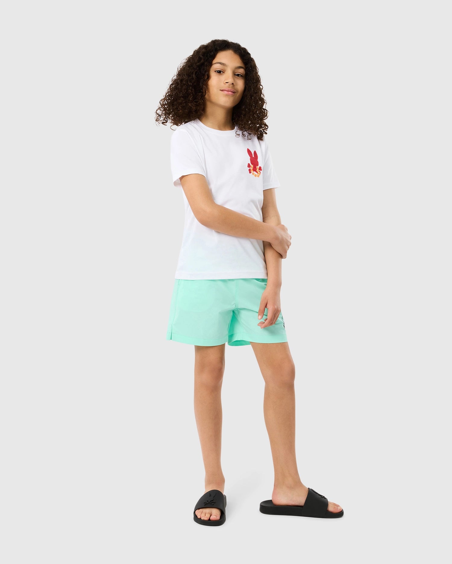 Head to toe view of a model wearing the pima cotton kids hawaii city tee