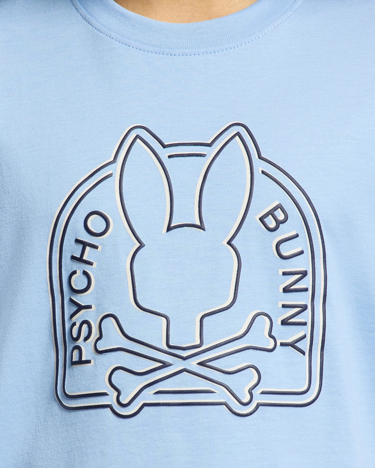 The KIDS MELBOURNE GRAPHIC TEE - B0U410F200, by Psycho Bunny, features a logo with an abstract rabbit head above crossed bones and "Psycho Bunny" on either side. It's crafted from eco-friendly Peruvian Pima cotton in blue.