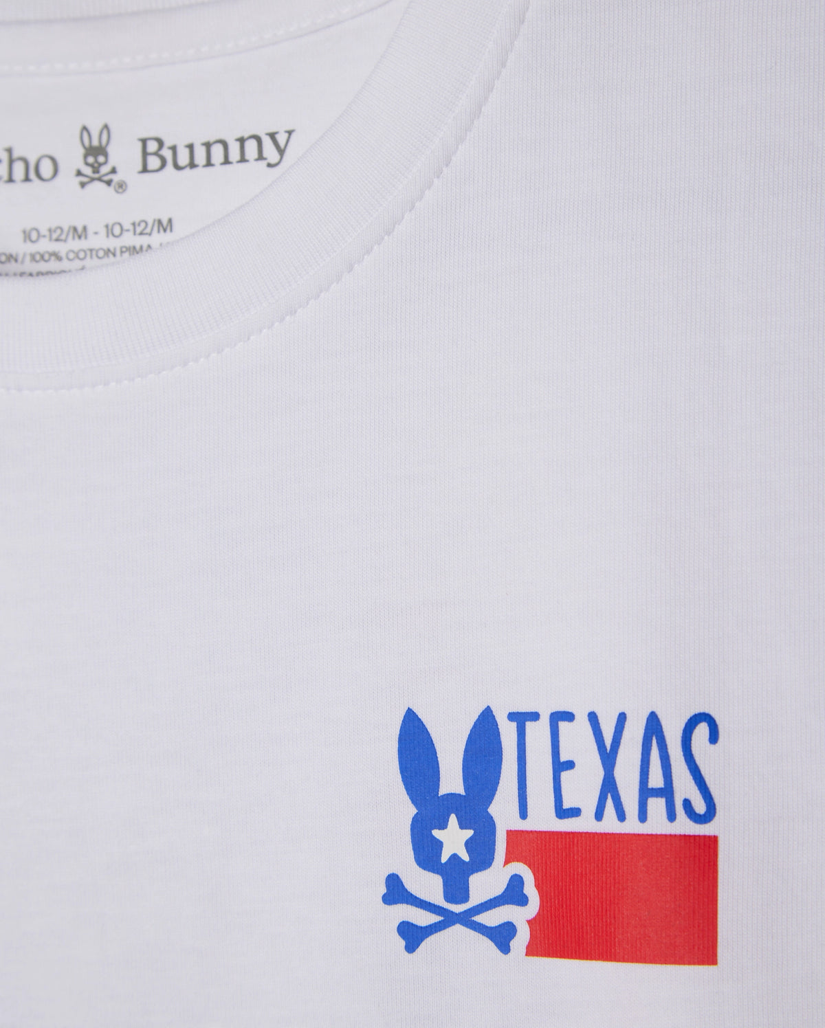 The KIDS TEXAS CITY TEE - B0U553B2PC by Psycho Bunny is made from soft Peruvian Pima cotton. It boasts a blue bunny logo with a star eye above crossbones, the word "TEXAS," and a simplified red flag design, combining style and comfort in every detail.
