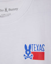 The KIDS TEXAS CITY TEE - B0U553B2PC by Psycho Bunny is made from soft Peruvian Pima cotton. It boasts a blue bunny logo with a star eye above crossbones, the word "TEXAS," and a simplified red flag design, combining style and comfort in every detail.