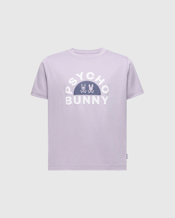 The KIDS GOLDIE GRAPHIC TEE by Psycho Bunny is made of soft Peruvian Pima cotton. The design showcases "PSYCHO BUNNY" in bold white letters, with two small bunny skull icons centered in a semicircle below, all on a lavender background.