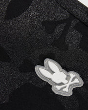 Close-up of a KIDS MALTA HYDROCHROMIC SWIM TRUNK - B0W321B2SW by Psycho Bunny, featuring a white embroidered logo of a stylized rabbit head.