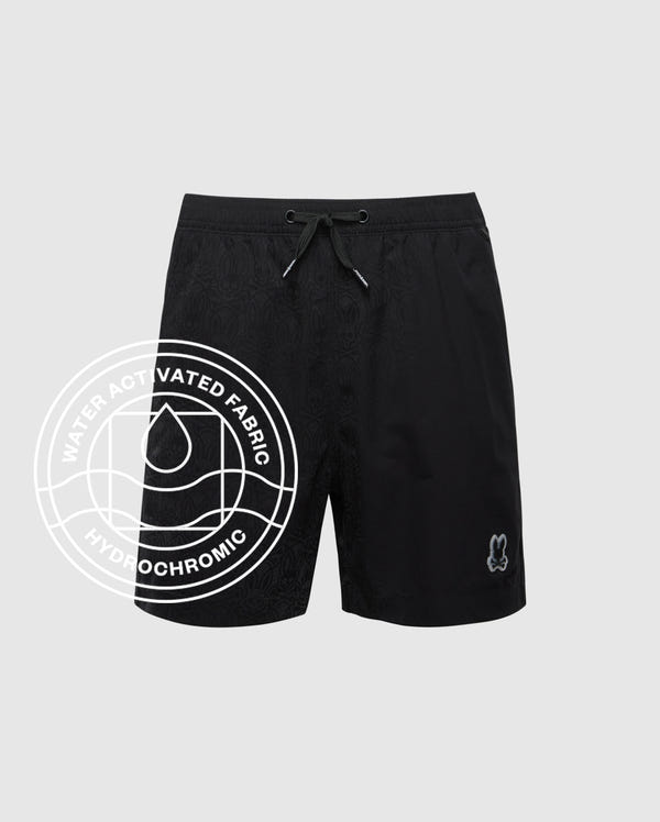 The Psycho Bunny MENS SAMOS 7 HYDROCHROMIC SWIM TRUNK features black fabric with a subtle embossed pattern, drawstring waistband, and bunny logo. Water Activated Fabric. Hydrochromic. B6W650F200.