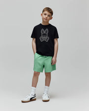 Black classic fit jersey t-shirt with a large white outline Psycho Bunny skull logo on the chest, paired with light green Kids Samos Hydrochromic Printed Swim Trunk featuring a white drawstring.
